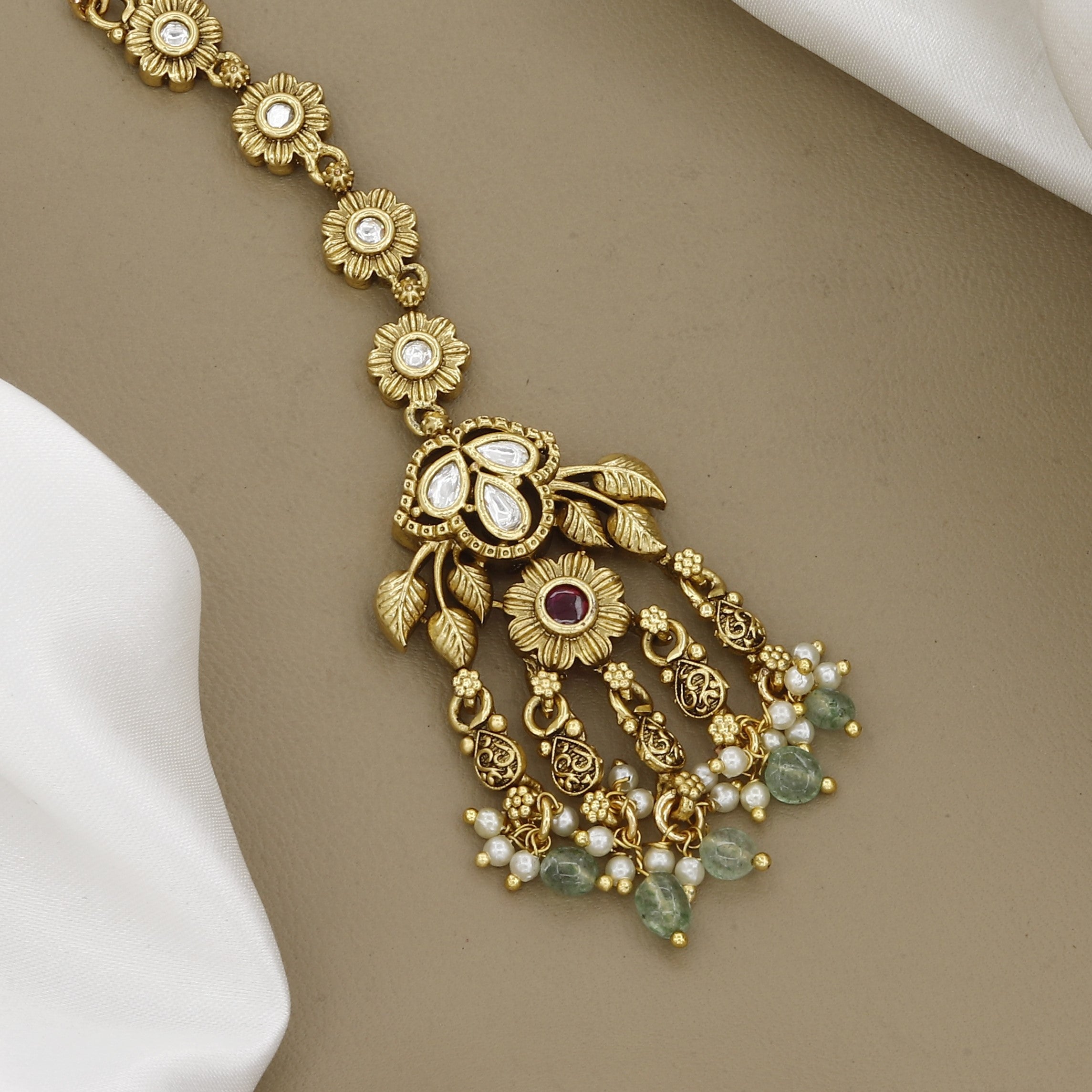 Floral Gold-Plated Maang Tikka with Kundan Accents and Green Beads
